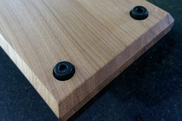 Underside of charcuterie board showing recessed rubber feet and rebated edge