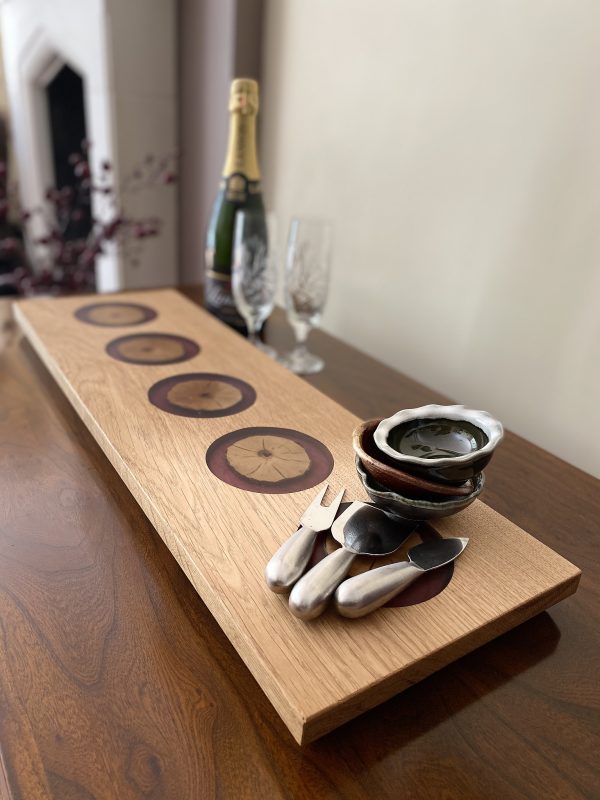 Oak Charcuterie Board with Purple Resin Inserts with bowls, glasses and champagne bottle