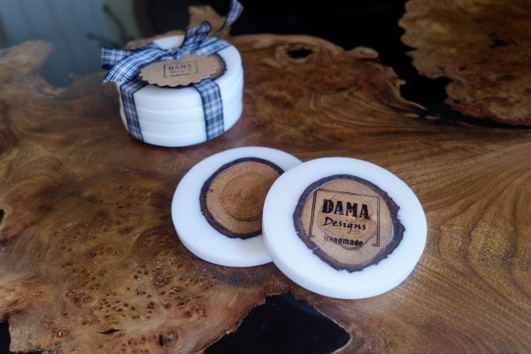 White resin and oak log coasters on table