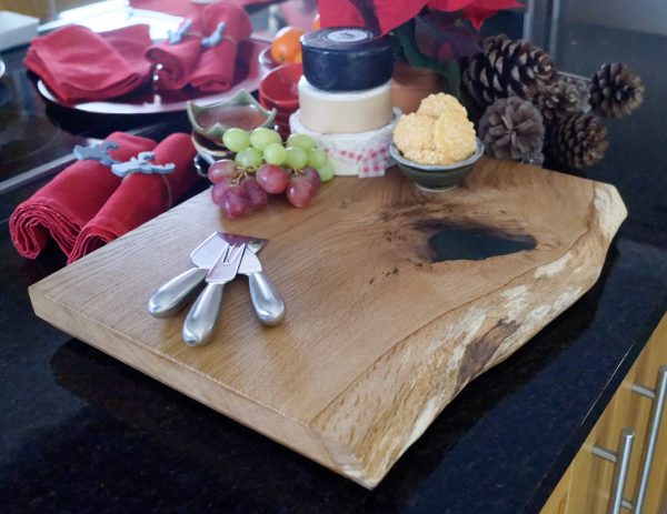 Oak Serving Board Decorated with Cheeses and Grapes