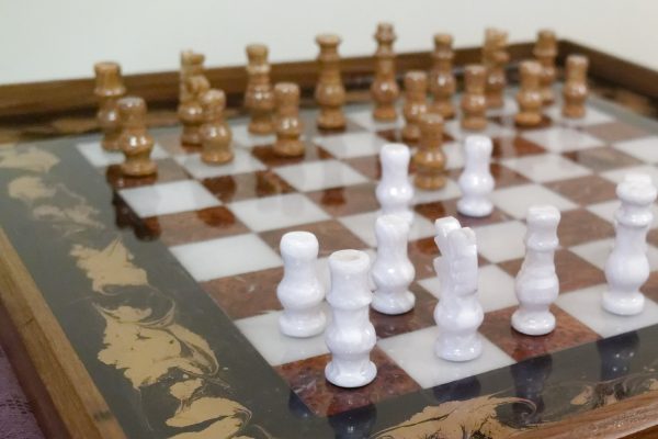 Close Up of Chess Board Ottoman Tray with Chess Pieces