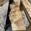 Close up of one of a pair of oak and resin benches