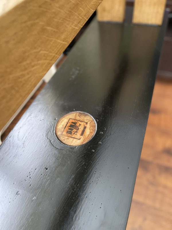 Underside of oak bench with branding