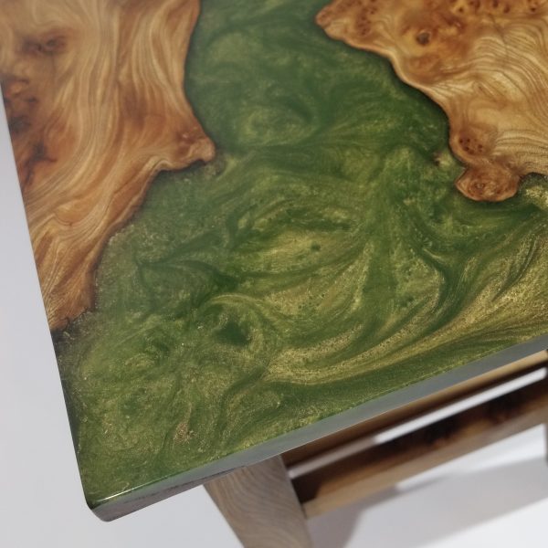 Close up corner of an ocassional table showing green resin river